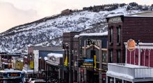 Park City's main street with a snow-covered mountain looming in the background, the Egyptian Theater in clear view.