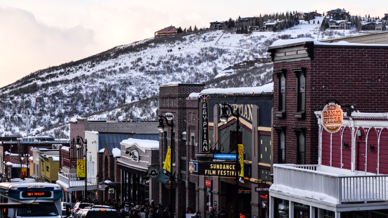 Park City's main street with a snow-covered mountain looming in the background, the Egyptian Theater in clear view.