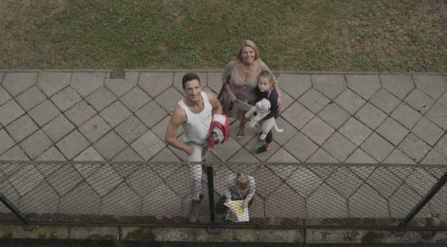 Four people and a dog seen from the point of view of a balcony
