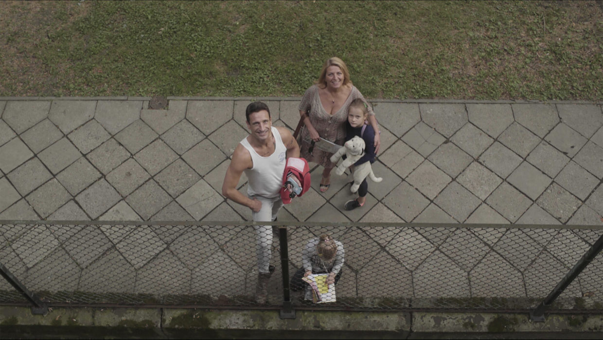 Four people and a dog seen from the point of view of a balcony