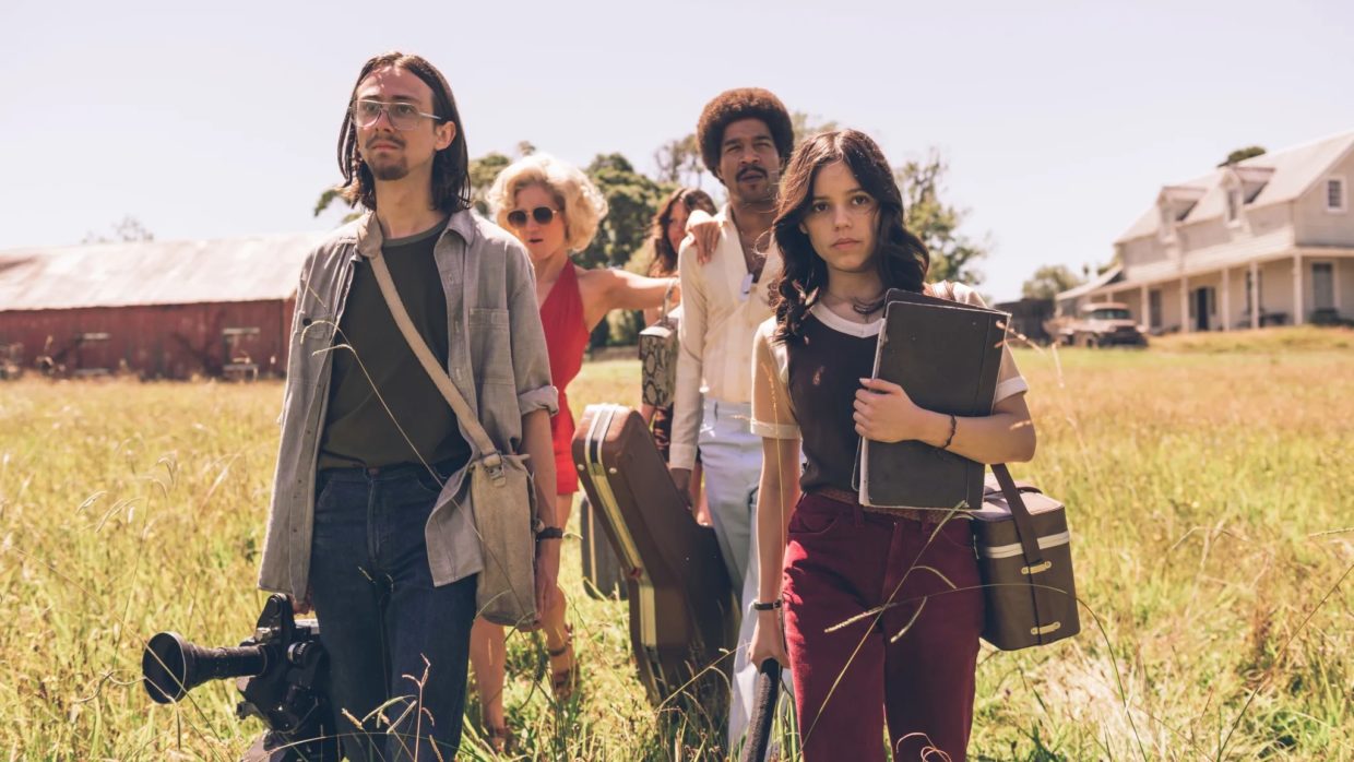 A group of filmmakers walking in a yellow field