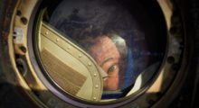 Expedition 27 Flight Engineer Cady Coleman peeks out of a window of the Soyuz TMA-20 spacecraft.
