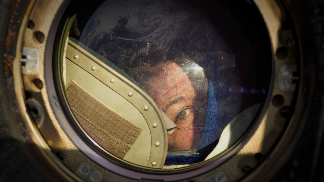 Expedition 27 Flight Engineer Cady Coleman peeks out of a window of the Soyuz TMA-20 spacecraft.