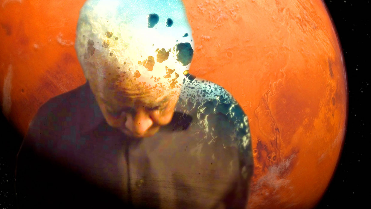 Poet Nikki Giovanni stands with his head bowed. He is superimposed over an image of the planet Mars.