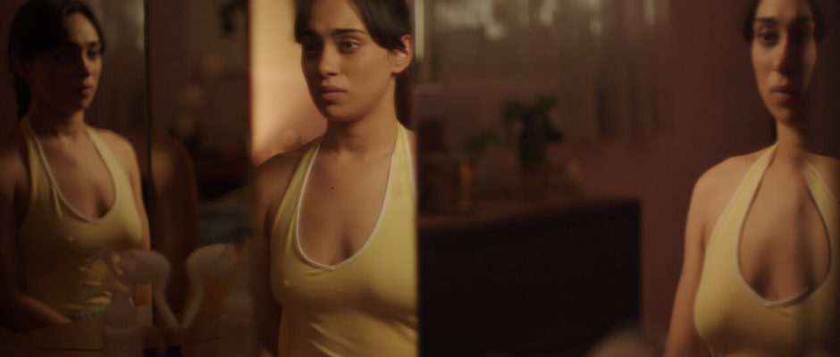 A woman stands in front of a triptych of mirrors, each slightly distorting her body's reflection.