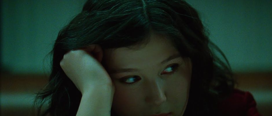 Singer-songwriter Lucy Dacus rests her head on her palm and looks to the side.