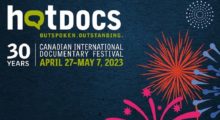 A logo for Hot Docs that features cartoon fireworks superimposed over a dark blue background.