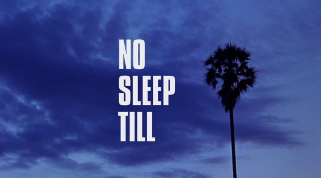 A single palm tree is captured amid a stormy, purple sky. Text to the left of the palm tree reveals a title card: No Sleep Till.