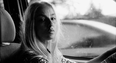 Ilinca Manolache driving a car in Radu Jude's Do Not Expect Too Much From the End of the World