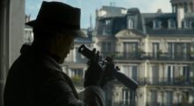 A shadowy man in a hat and trench coat peers through a telescope at the street below.