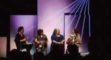 A panel of four people speaks after a film screening.