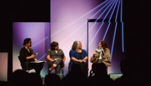 A panel of four people speaks after a film screening.