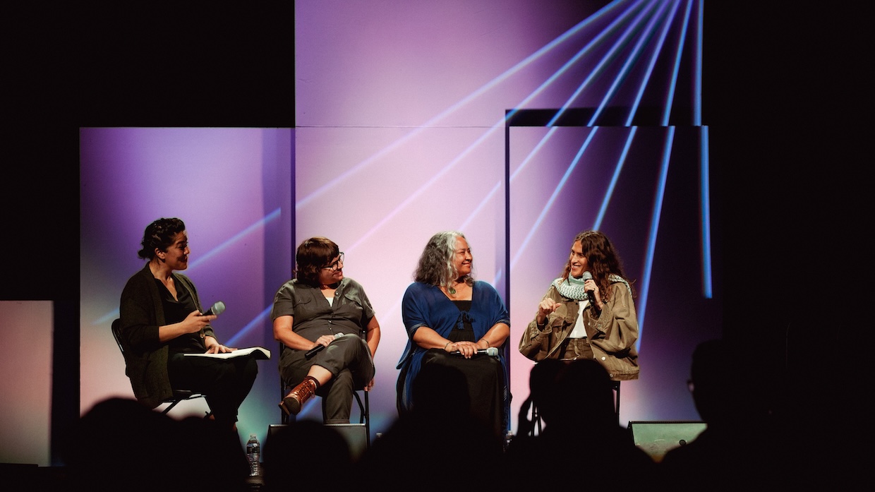 A panel of four people speaks after a film screening.