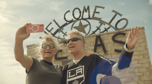 Two people take a selfie outside a Texas tourist spot.