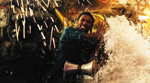 A man struggles to close a door on a flooding submarine.