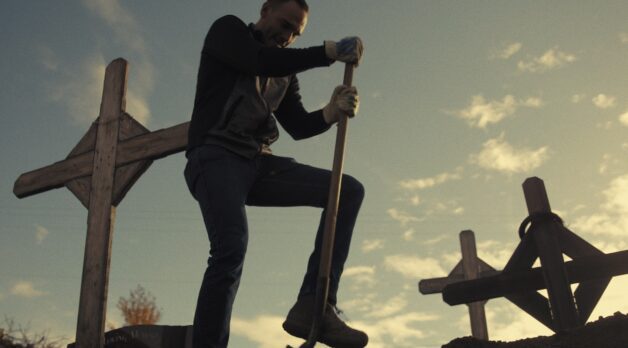 A man digs in a graveyard.