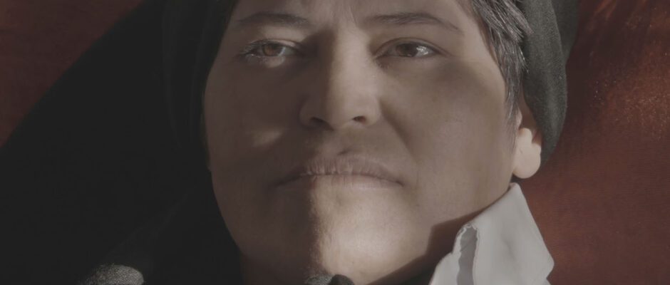 A close-up of an Iranian woman looking into the distance.