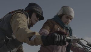 An Iranian woman teaches a younger girl how to ride a motorcycle.