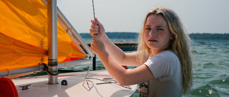 A white woman is sailing.