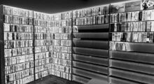A reverse negative image of a home DVD library.