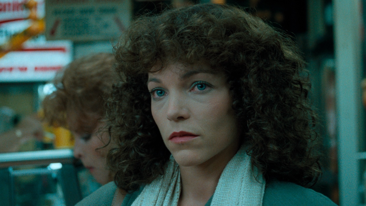 A woman stares pensively.