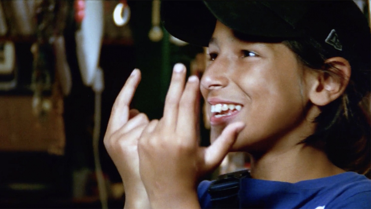 roikin-3_CIMC_2470299 | Filmmaker Magazine A young boy holds his hands and makes signs.