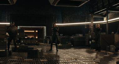 A woman with a gun in a vault.