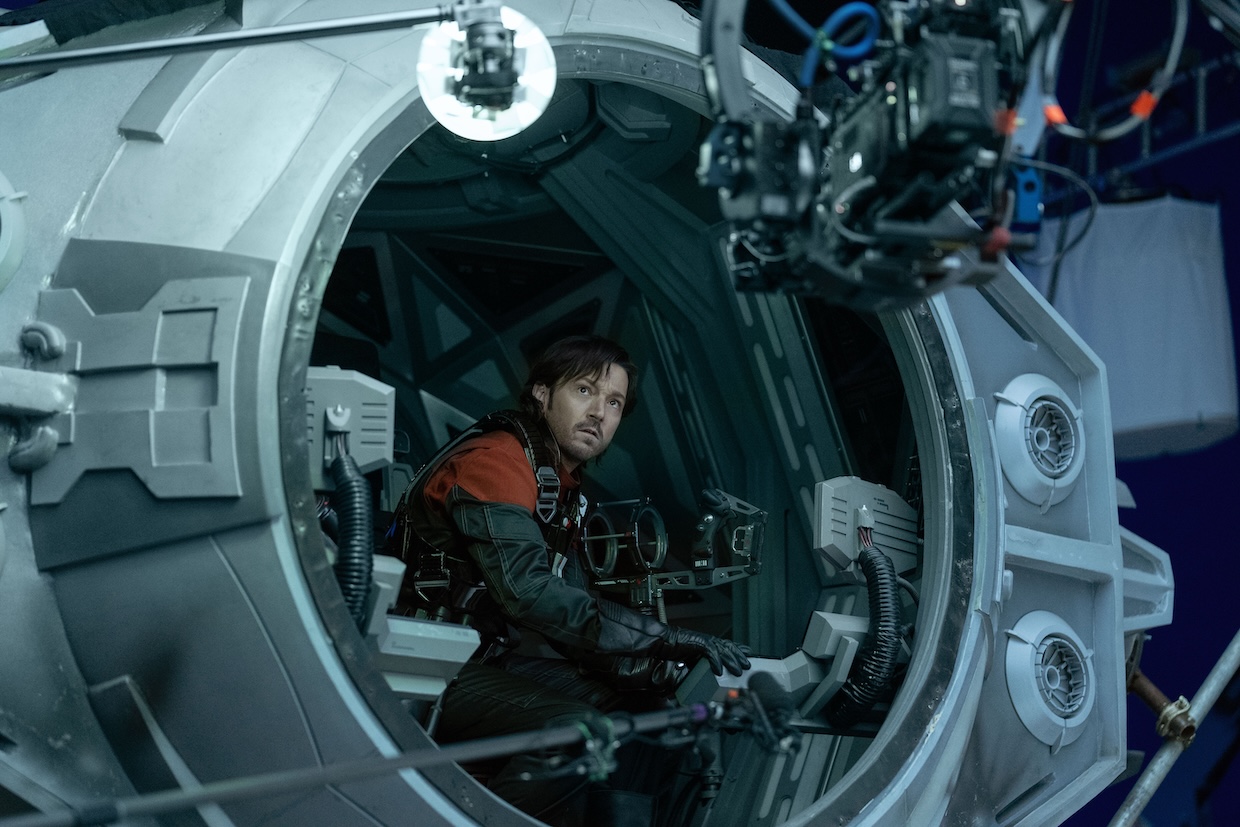 A man perched in a spaceship cockpit.